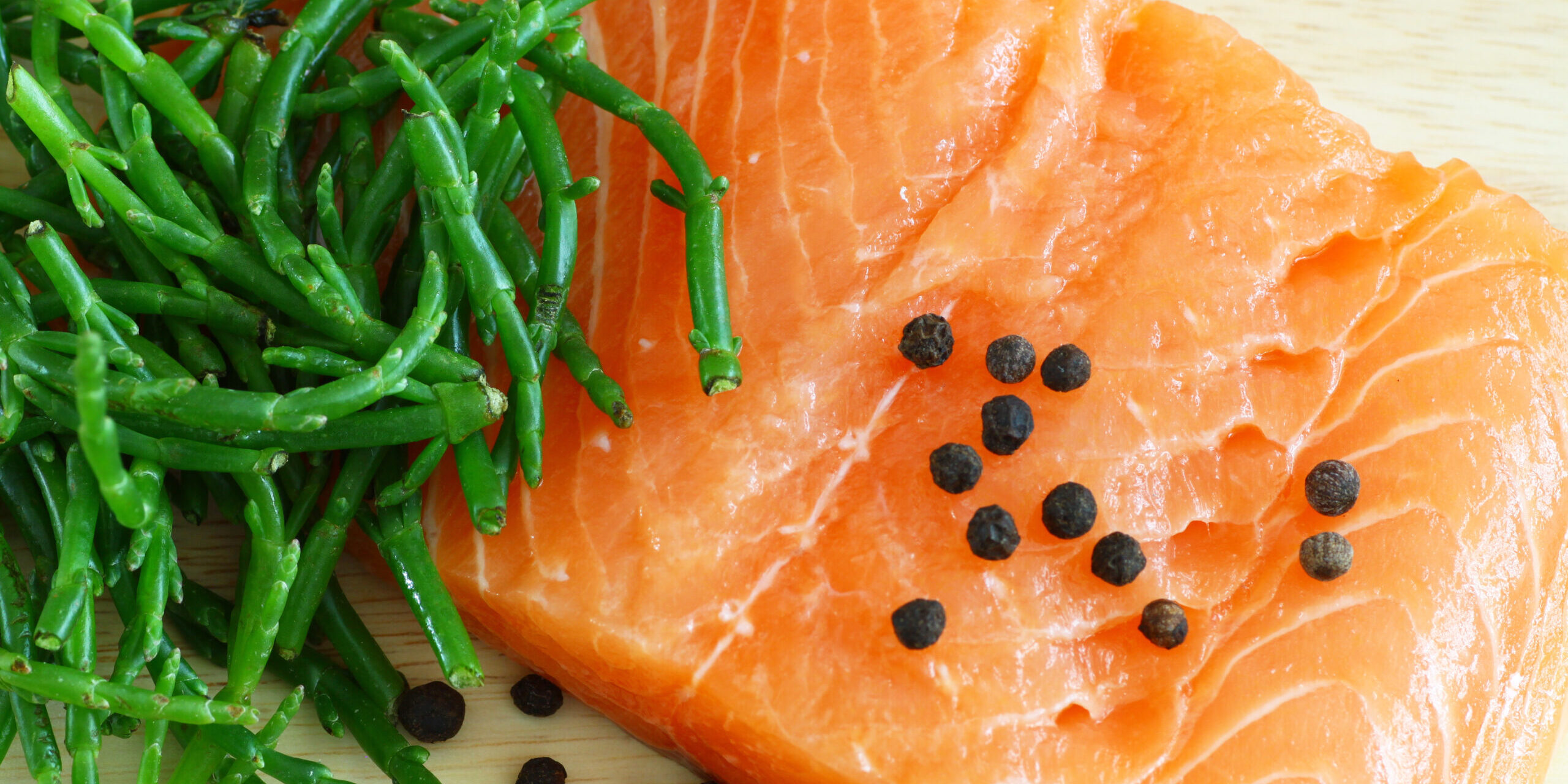 Salmon with samphire Samphire served next to a piece of fish