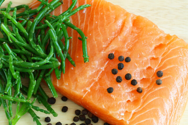 Salmon with samphire Samphire served next to a piece of fish