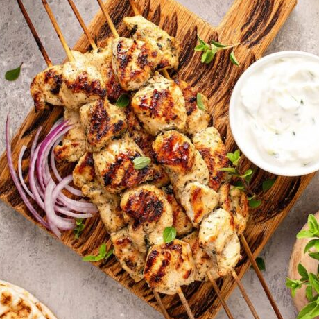 chicken on skewers with dip on the side