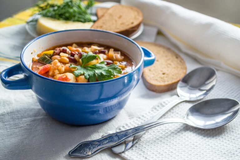 soup in a bowl on a table with a side of bread