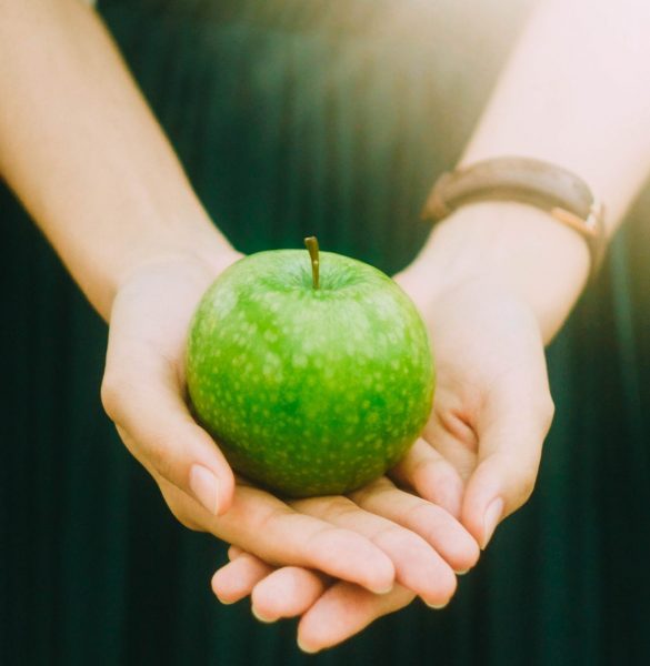 apple in the palm of hand