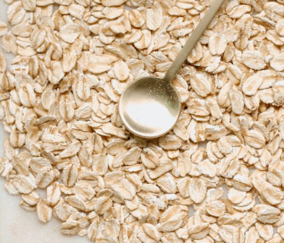 oats on a table with a golden spoon