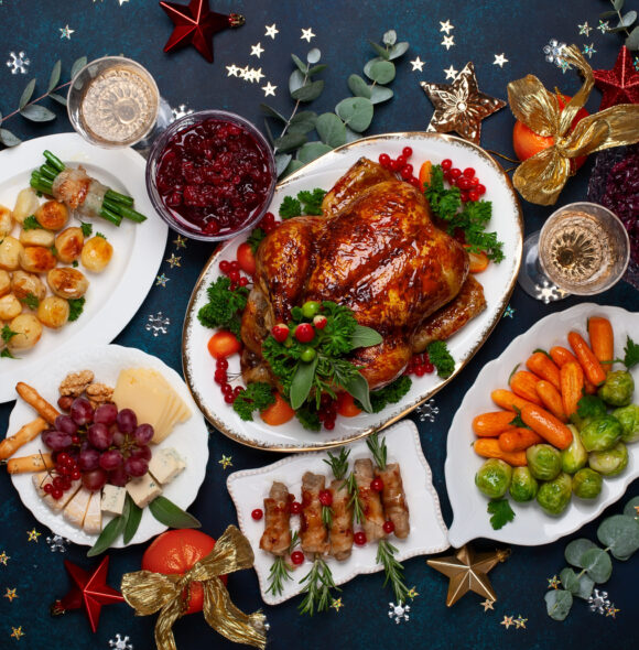 Concept of Christmas or New Year dinner with roasted chicken and various vegetables dishes. Top view.