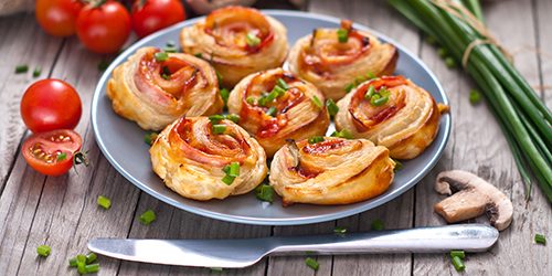 Puff pastry rolls with ham and chese. Baked snacks