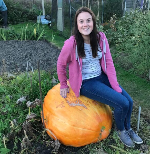 Rosie sat on her Grandad's giant pumpkin