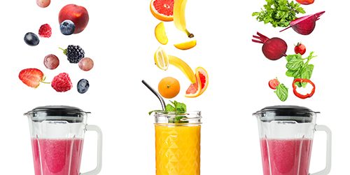 Different healthy smoothies with falling ingredients on white ba