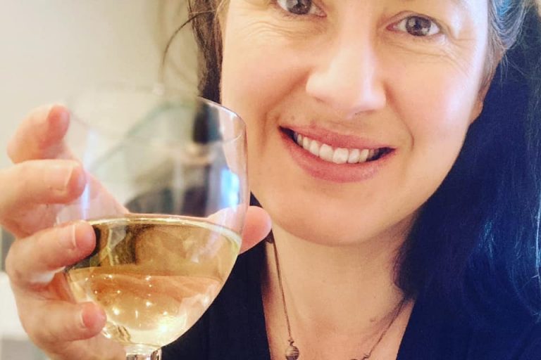 Emma holding a glass of wine