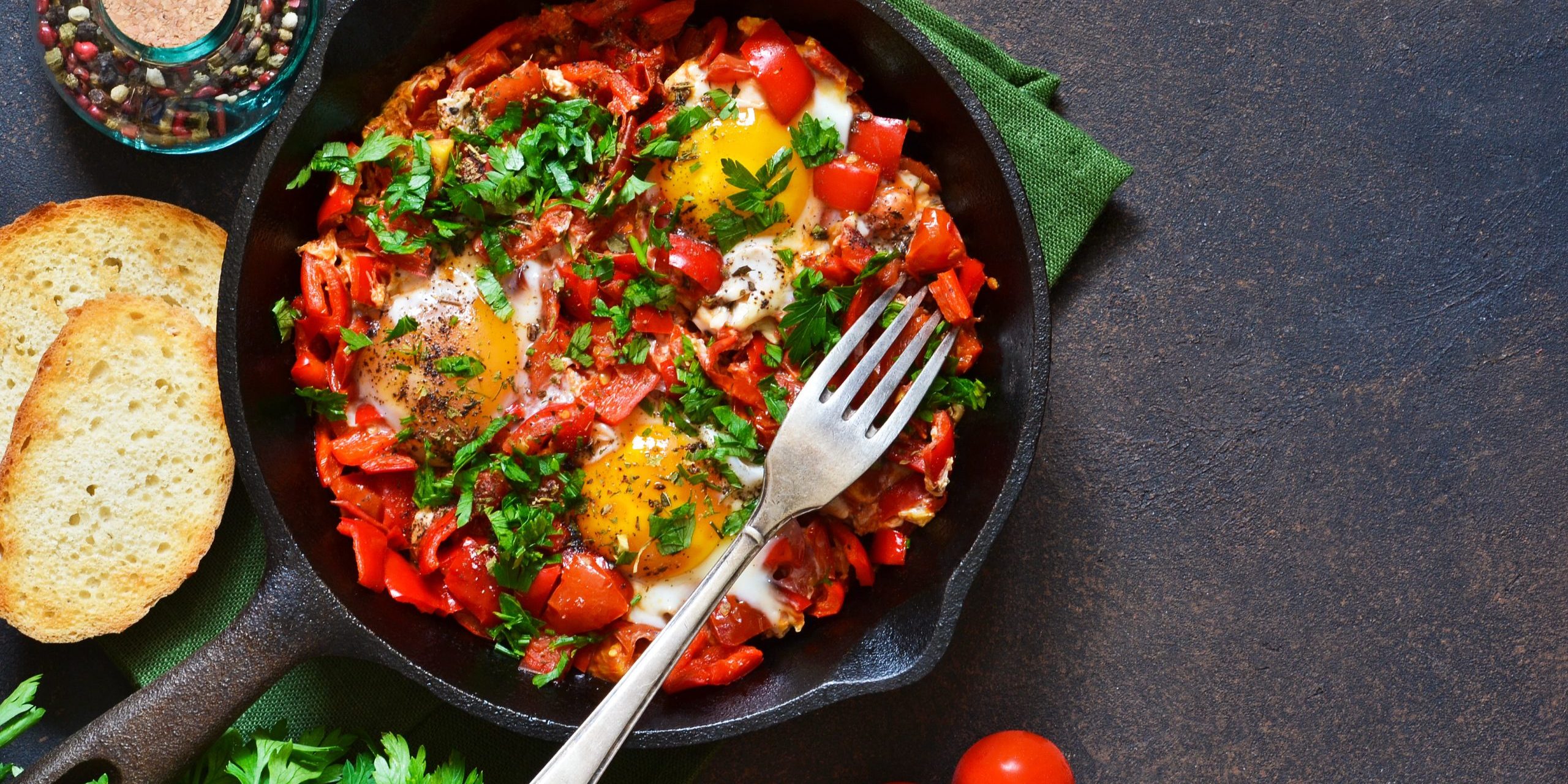 Shakshuka is a traditional breakfast of Israeli cuisine. Eggs fried in tomato sauce with pepper, onions and spices.