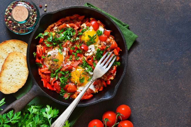 Shakshuka is a traditional breakfast of Israeli cuisine. Eggs fried in tomato sauce with pepper, onions and spices.