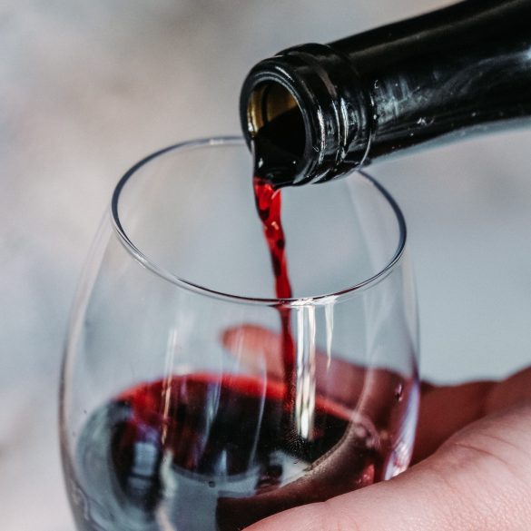 red wine being poured into a glass