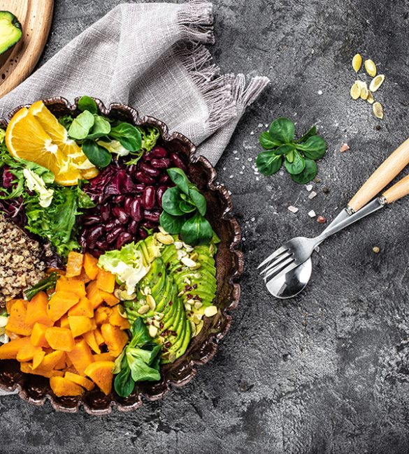 Salad with quinoa, avocado, sweet potato, beans on dark background. superfood concept. Healthy, clean eating concept. Vegan or gluten free diet. top view.