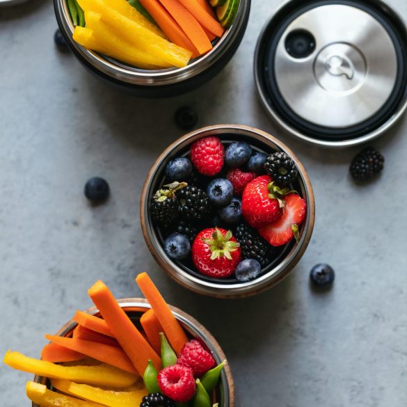 bowls of healthy snacks including fruit and vegetables
