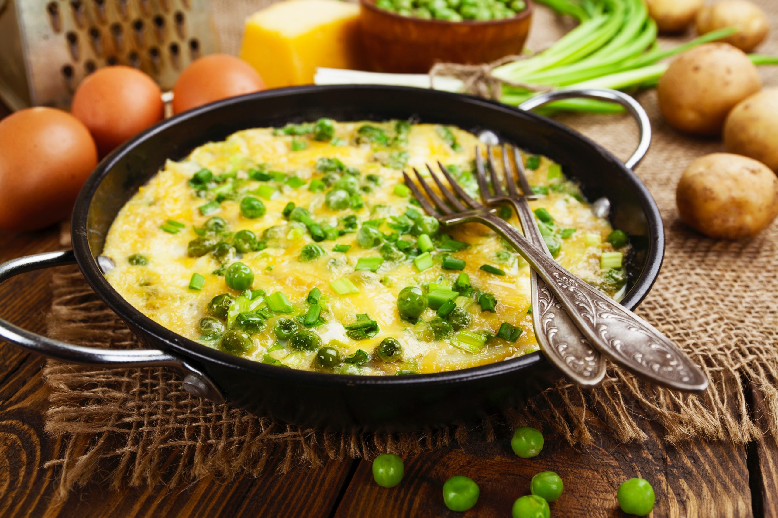 Omelette with green peas, potatoes and cheese