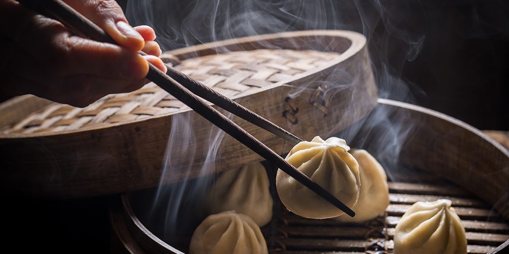 Fresh and hot manti dumplings in bamboo steamer