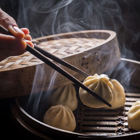 Fresh and hot manti dumplings in bamboo steamer