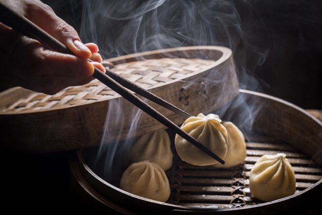 Fresh and hot manti dumplings in bamboo steamer