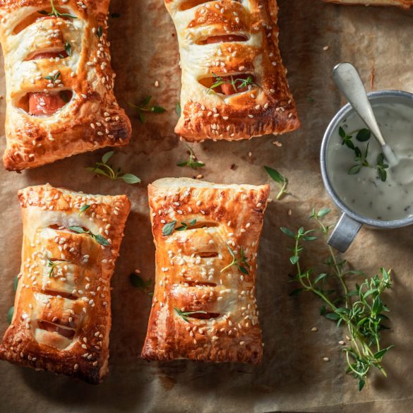 Tasty and fresh sausage roll with herbs and sesame seeds