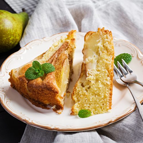 Homemade pie with pears and almond flour  on dark background.