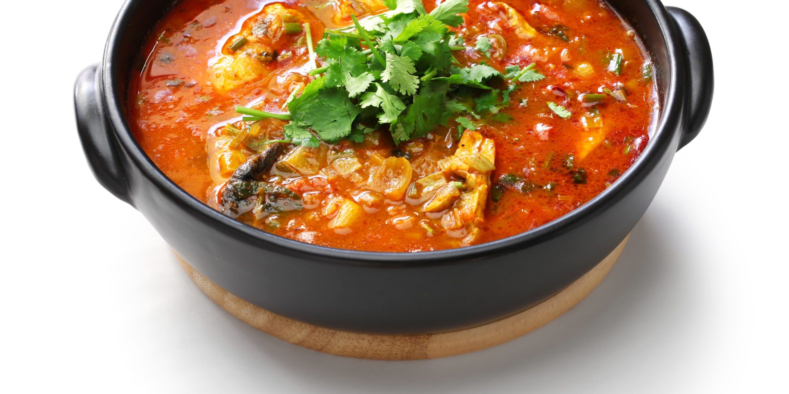 moqueca capixaba, brazilian fish stew isolated on white background