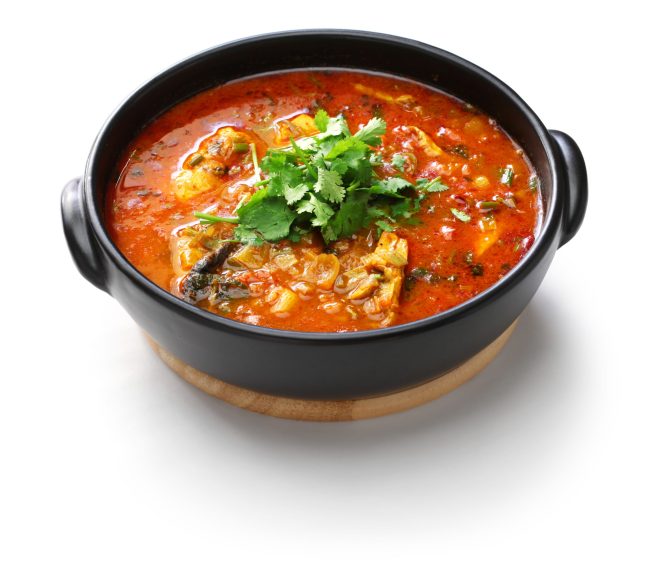 moqueca capixaba, brazilian fish stew isolated on white background