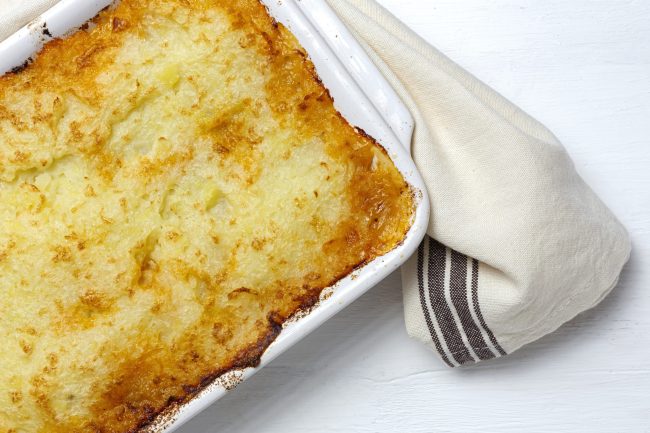 Traditional homemade shepherd pie on white background. Cottage foot