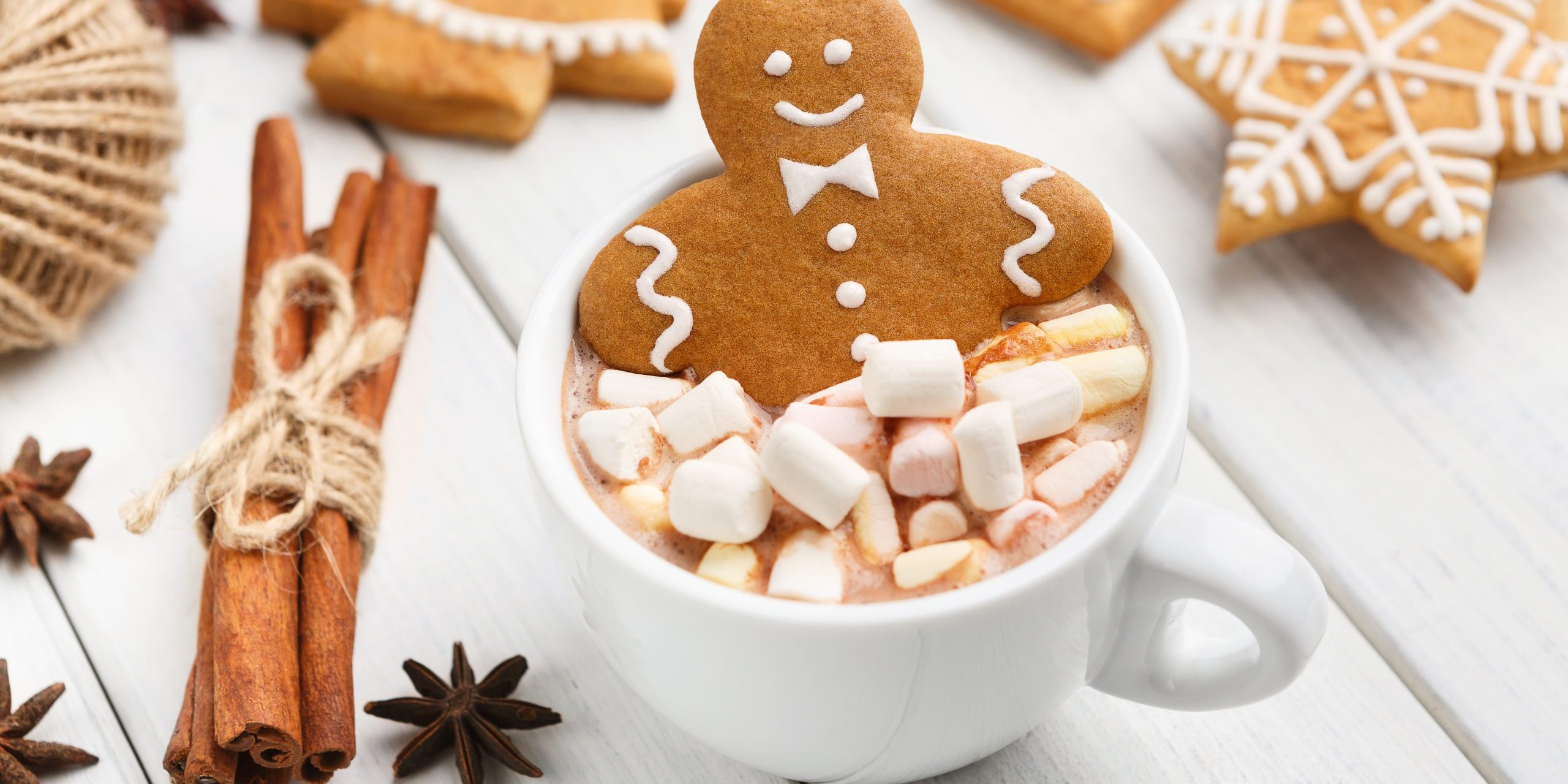 Gingerbread cookie man in cup of hot chocolate