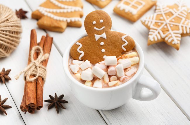 Gingerbread cookie man in cup of hot chocolate