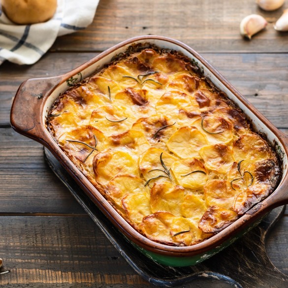 Potato casserole with garlic and rosemary Potato casserole with garlic and rosemary. Simple and tasty food. Village lunch.