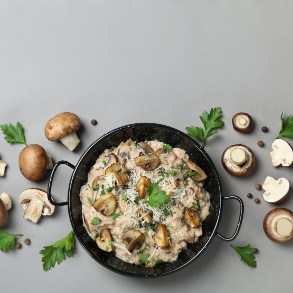 Concept of tasty food with risotto with mushrooms on gray background