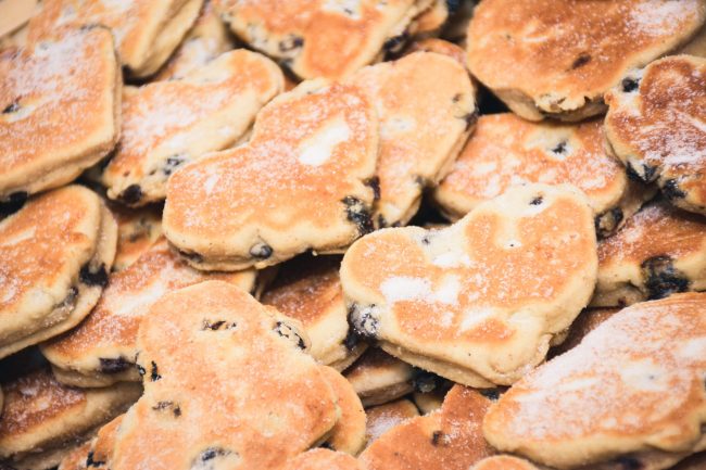 Traditional Welsh cakes with raisins and powdered sugar macro in