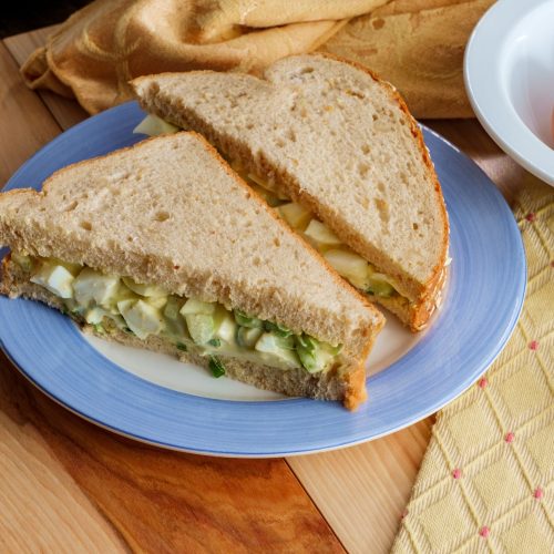 American egg salad mayonnaise sandwich on triangle sliced multigrain oat bread