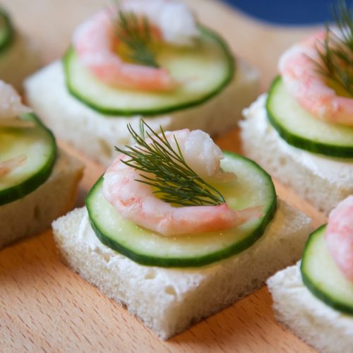 Canape with cream cheese, cucumber and shrimp.