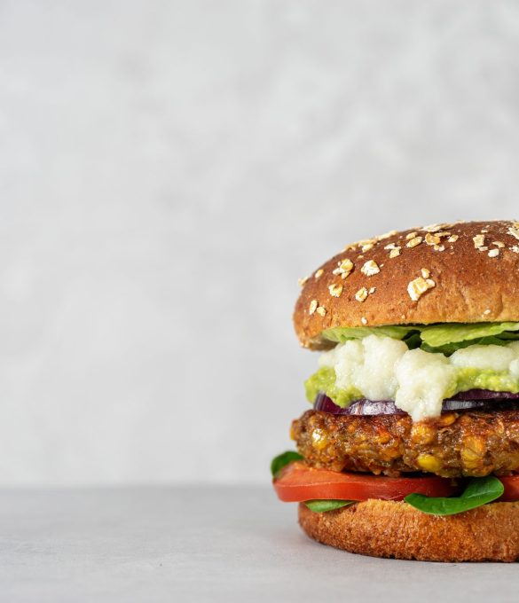 Vegan food concept. Lentils burger with vegetables and creamy cauliflower sauce on light gray background. Copy space