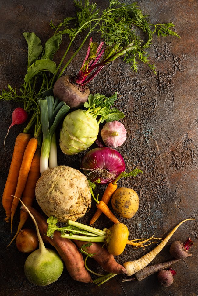 Assortment of Vegetables and root vegetables on textured backgro
