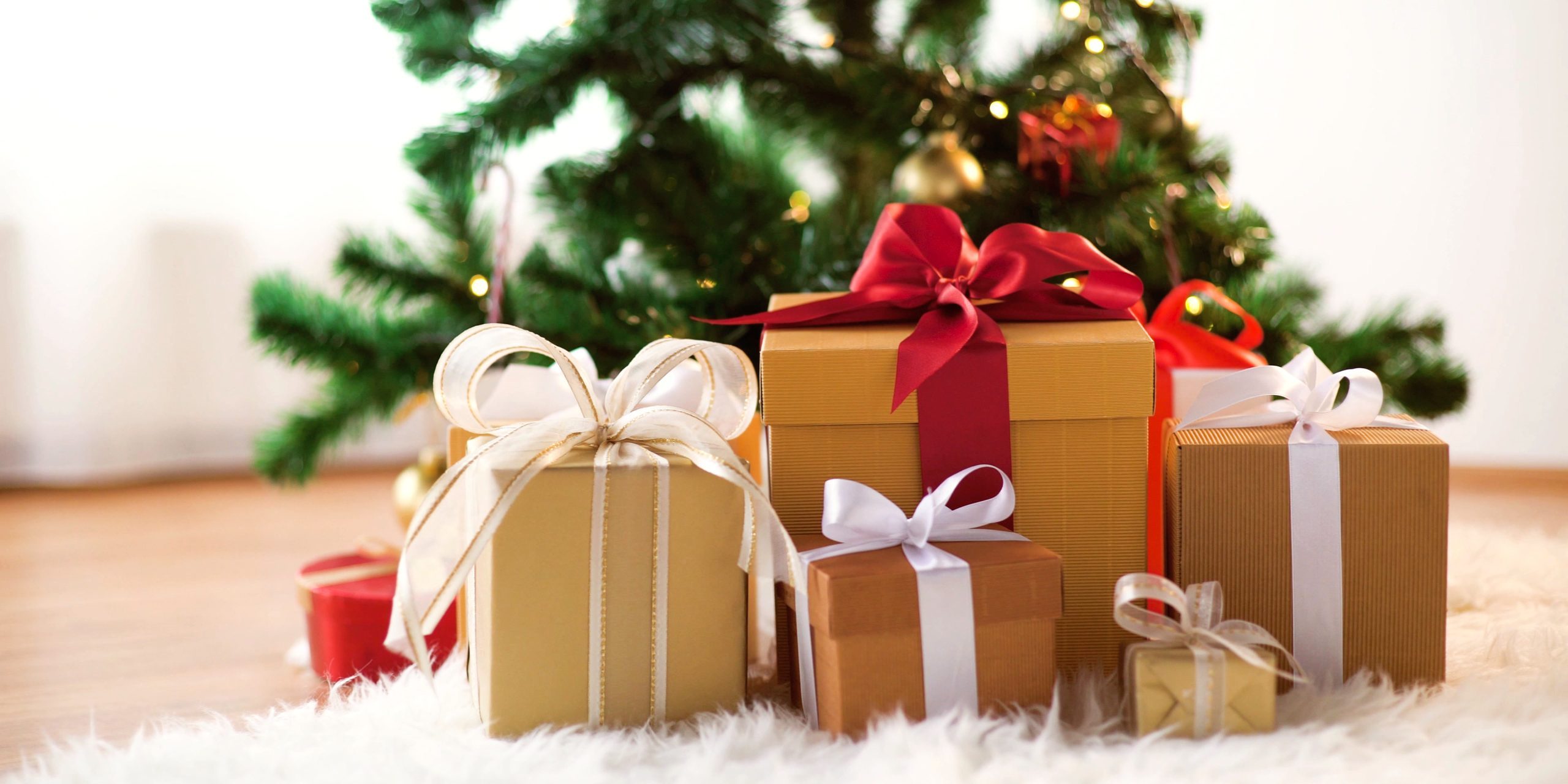 gift boxes on sheepskin at christmas tree