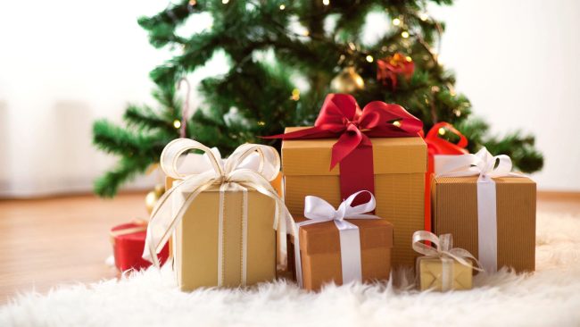 gift boxes on sheepskin at christmas tree
