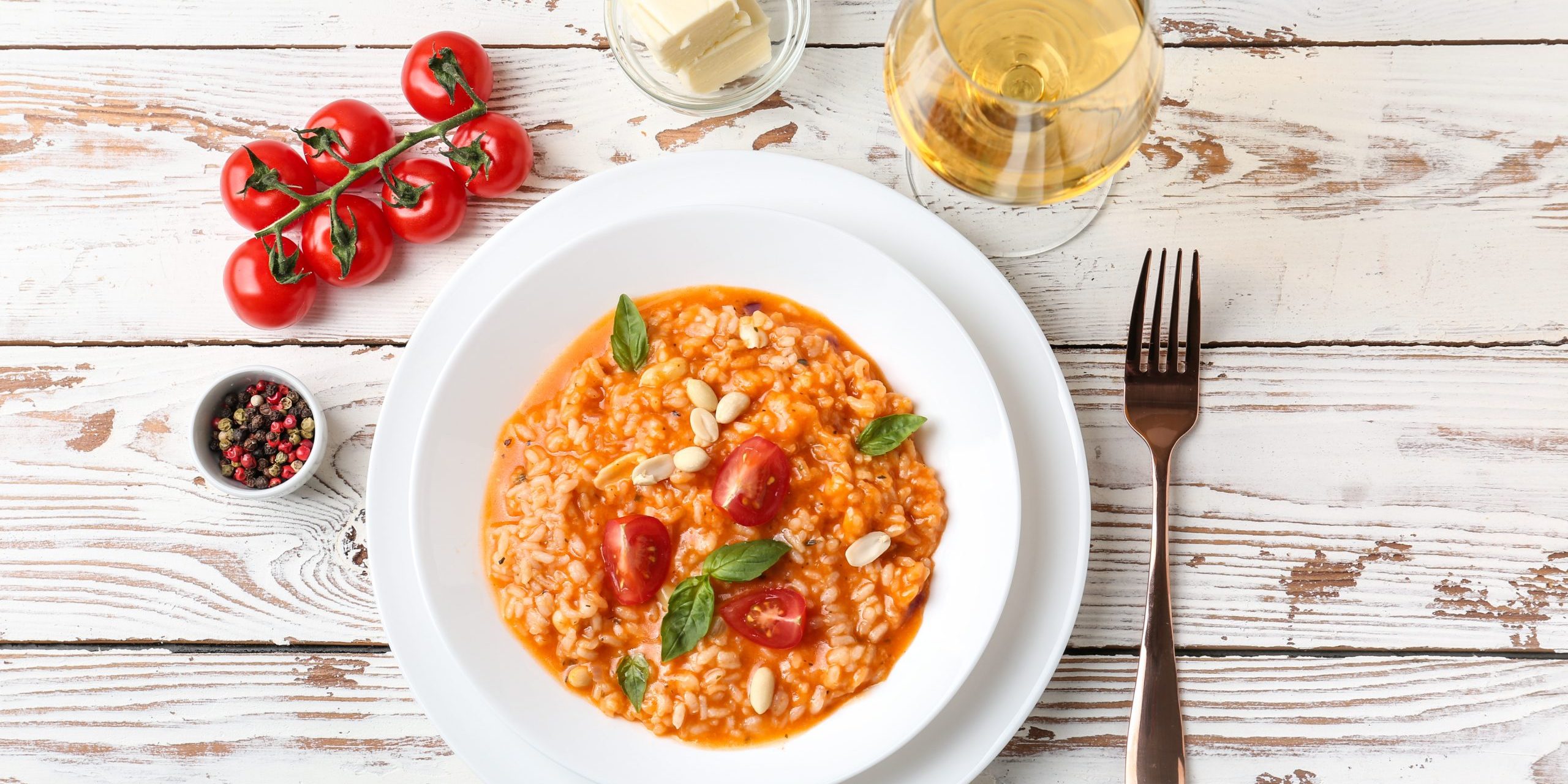 Plate with tasty risotto on wooden table