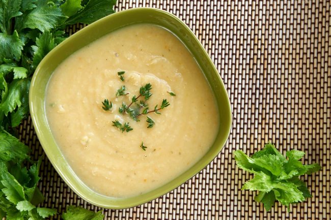 Tasty cream of celeriac soup in a green bowl