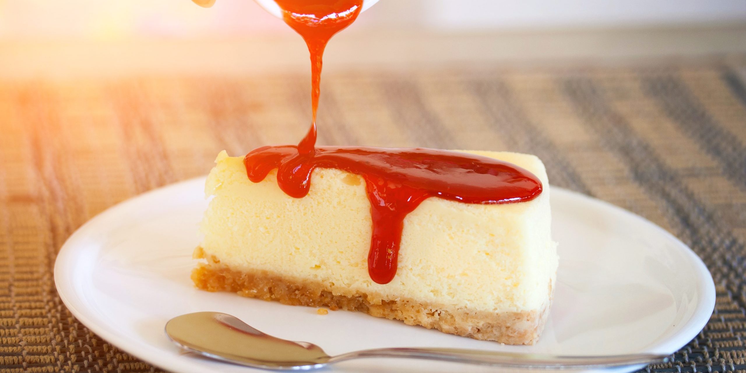 Pour strawberry sauce into cheesecake