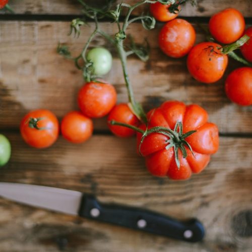 Fresh cherry tomatoes on rustic wooden table, Top view with copy space.