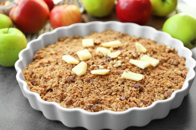 Baking dish with apple crisp on table