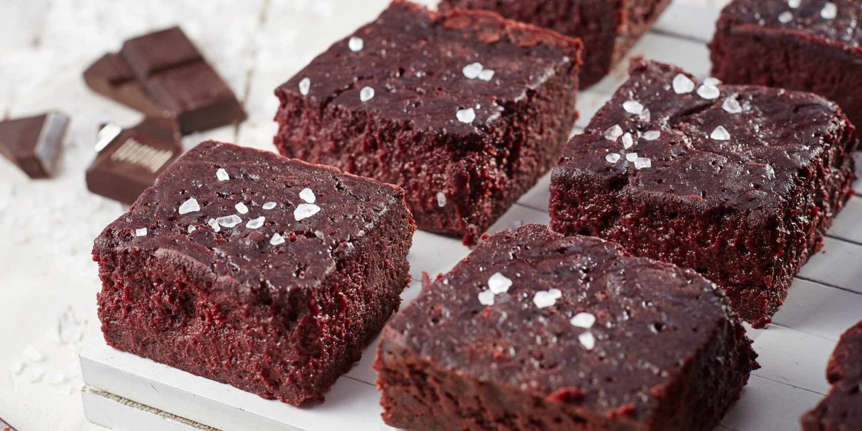Beetroot brownie on a white wooden background from a side