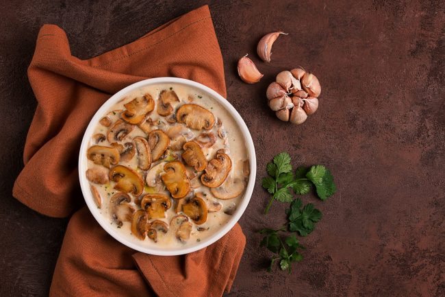 champignons in creamy garlic sauce, with herbs and spices, gravy