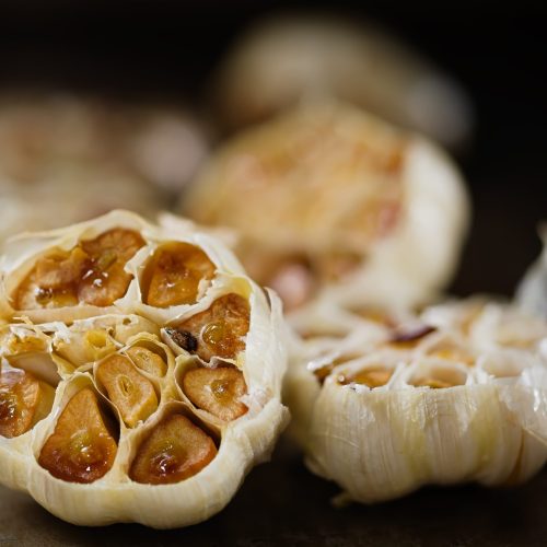 close up of rustic roasted baked garlic