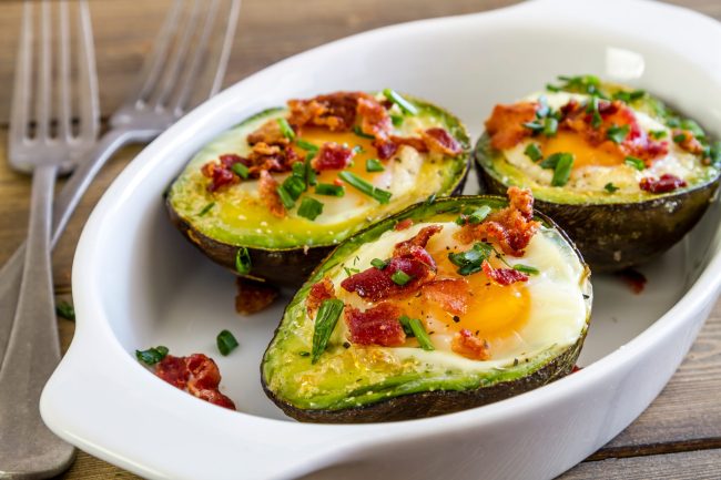 Baked avocados and eggs with bacon and chives