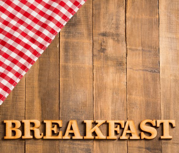 Picnic breakfast - Checkered red napkin and wooden letters. Background for design