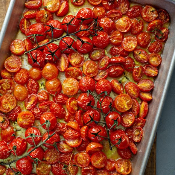 Cherry tomatoes roasted with garlic and spices on a baking tray