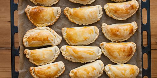 fresh empanadas – traditional food on baking tray