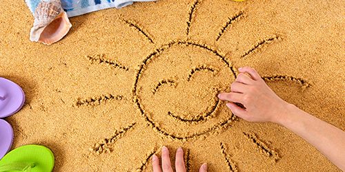 Child with smiley sun drawing
