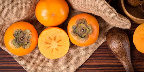 Top view of Persimmon fruit on rustic sack